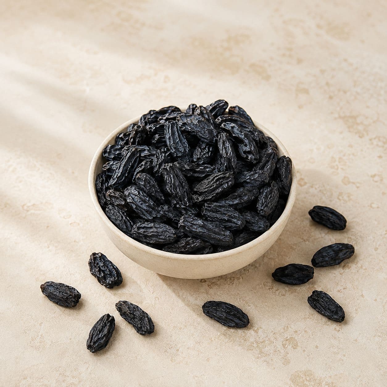 Dark seedless black kismis in an ivory bowl